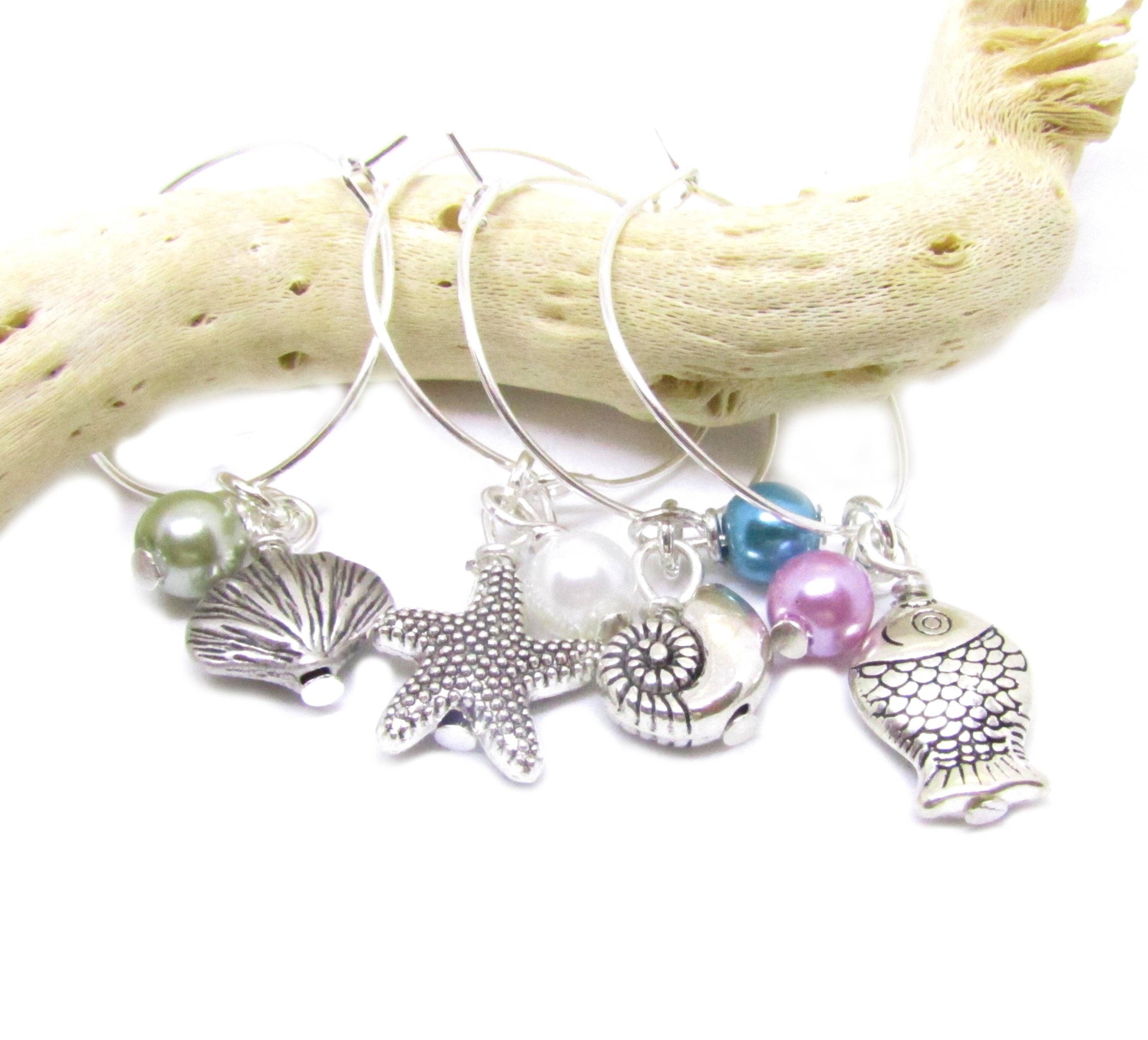 Coastal wine glass charm set with shell, starfish and fish charms paired with green, pink, white and teal pearl beads
