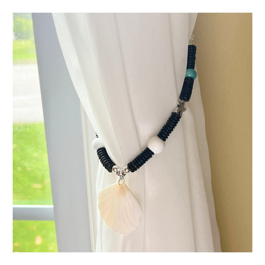 Set of two seashell and wood bead curtain tiebacks shown styled on sheer curtains — handmade coastal beach home decor