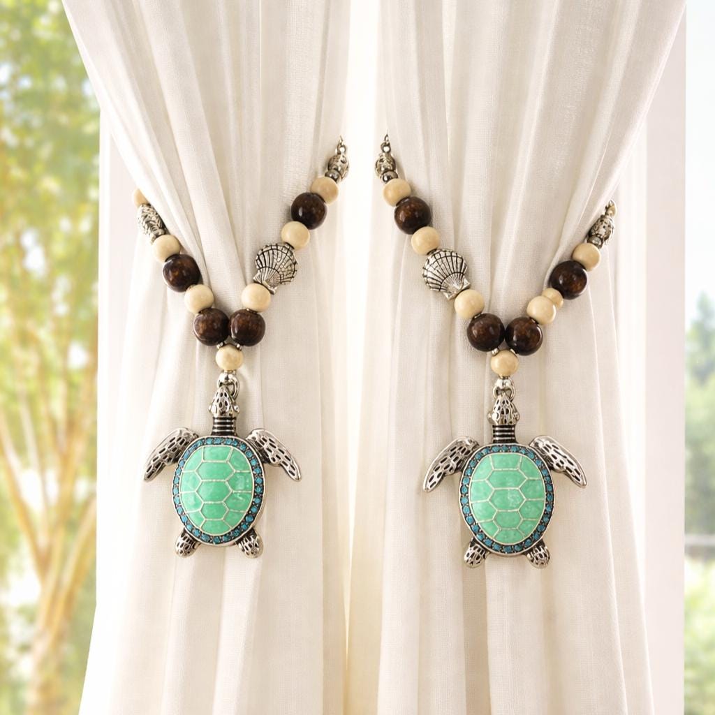 Set of two sea turtle beaded curtain tiebacks shown styled on sheer curtains — handmade coastal beach home decor