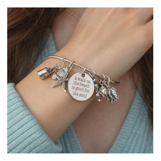 Sea turtle and mermaid beach charm bangle bracelet shown on a wrist — handmade ocean jewelry