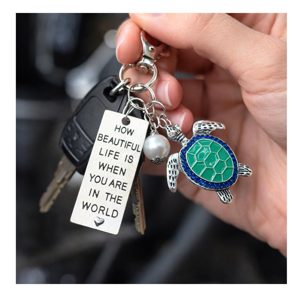 Abalone sea turtle keychain shown on a flat lay — beach inspired ocean keyring handmade jewelry

