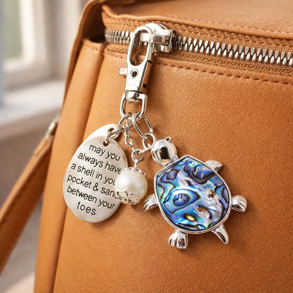 Abalone shell sea turtle keychain shown as a beach bag charm — handmade coastal beach accessory