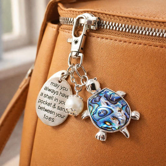 Abalone shell sea turtle keychain shown as a beach bag charm — handmade coastal beach accessory