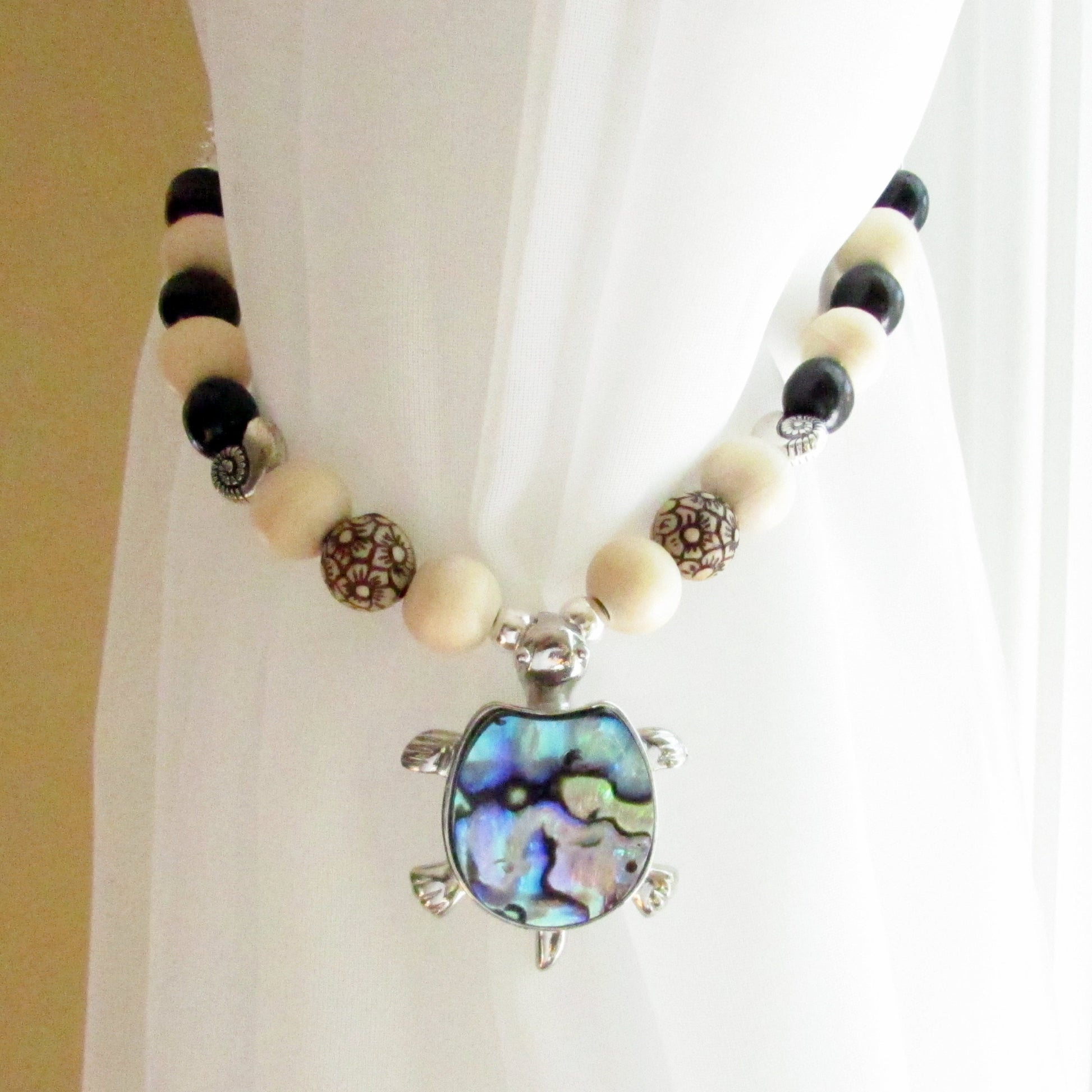 Sea turtle pendant with natural abalone shell center on beaded curtain tieback strand, beach cottage decor