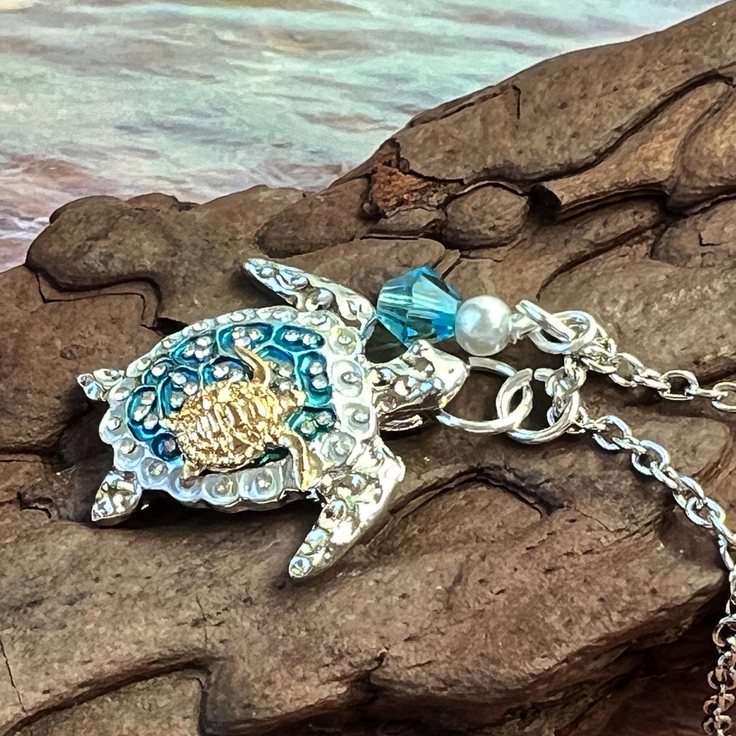 Gold tone momma and baby sea turtle necklace with lobster claw clasp, heartfelt coastal jewelry for turtle lovers