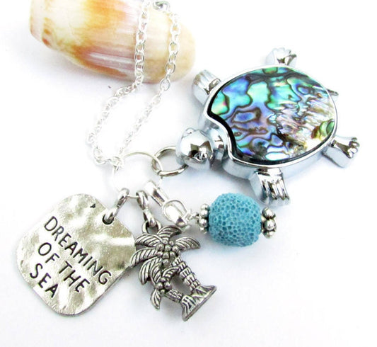 Abalone shell sea turtle car charm shown on a flat lay — handmade ocean rearview mirror accessory