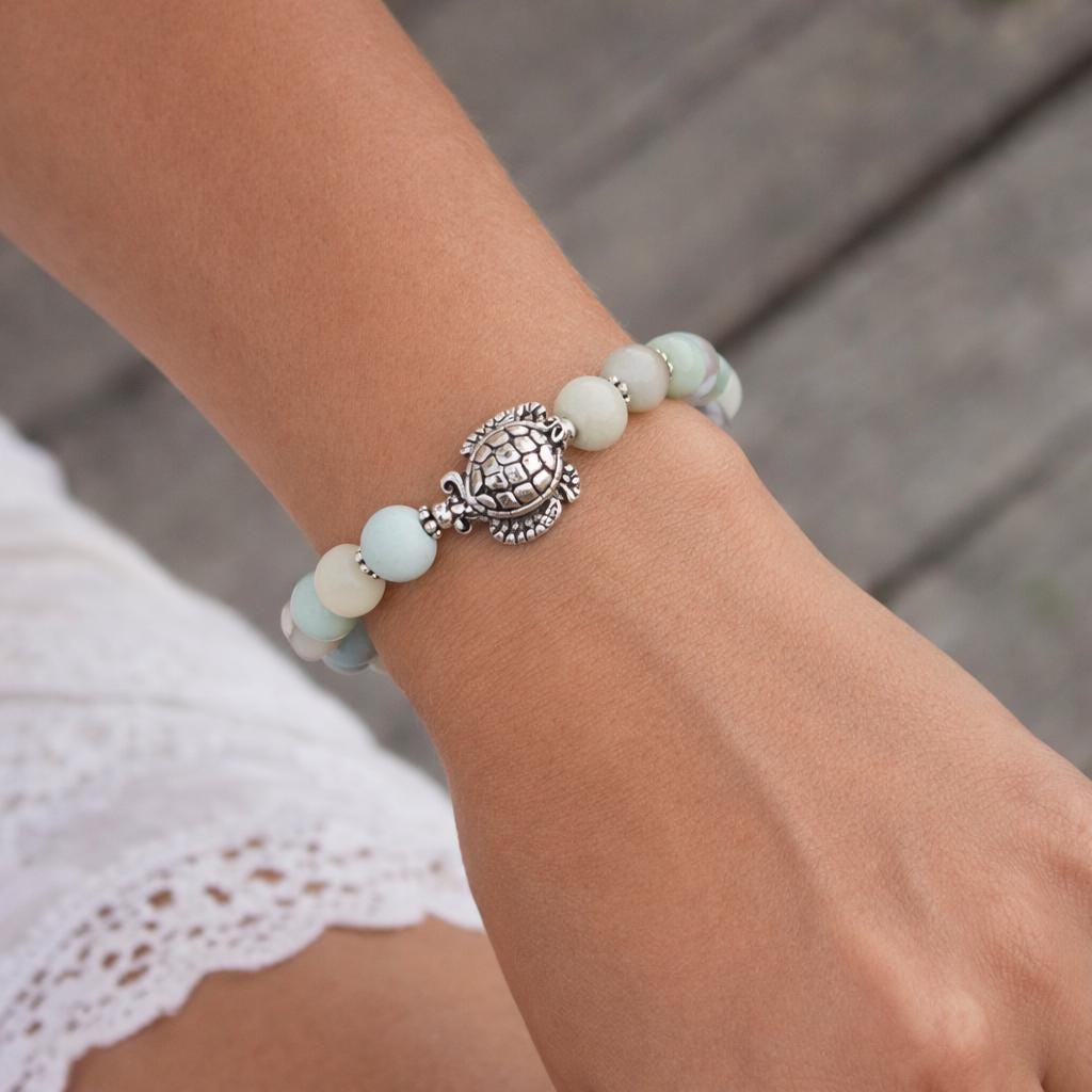 Amazonite stone sea turtle heart charm bracelet shown on a wrist — handmade ocean jewelry