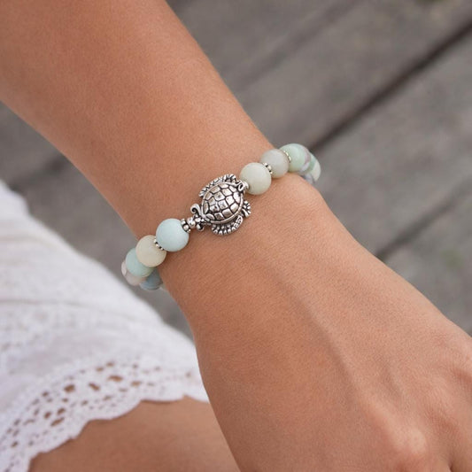 Amazonite stone sea turtle heart charm bracelet shown on a wrist — handmade ocean jewelry
