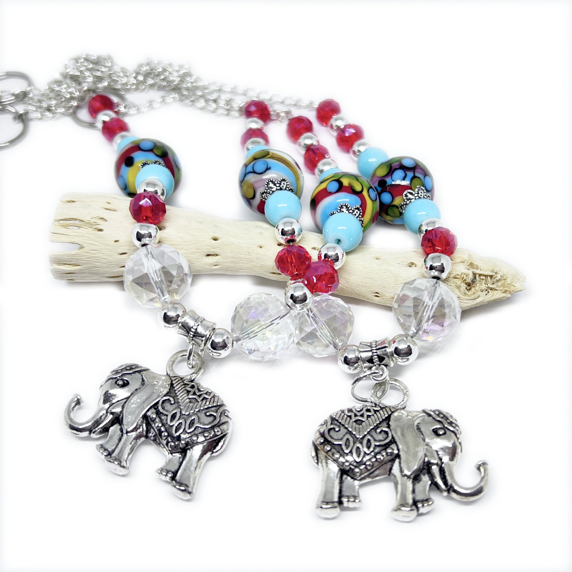 Handcrafted sea glass curtain tieback with blue tumbled sea glass pendants and white shell beads