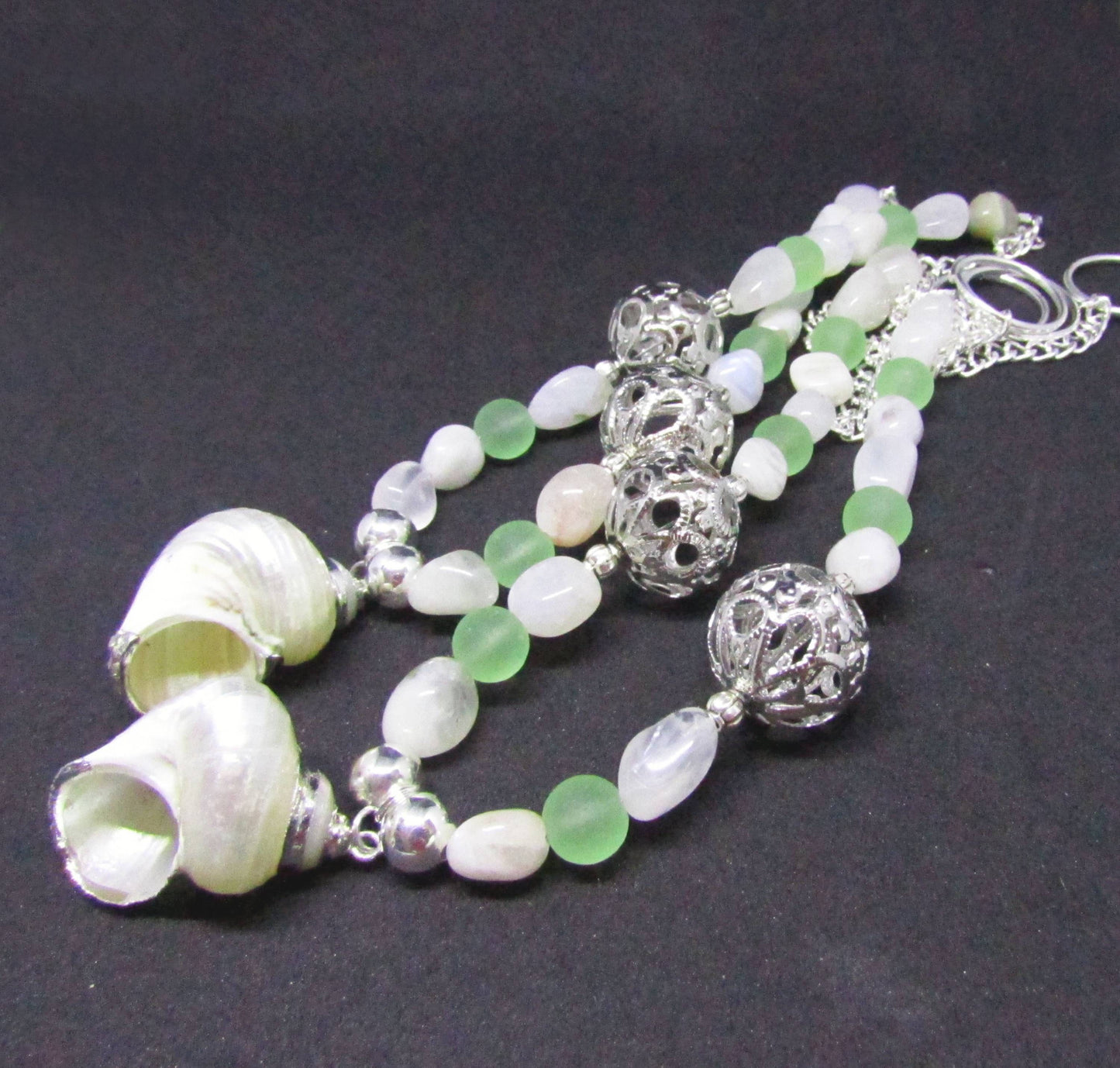 Natural white seashell with silver trim focal pendant on beaded curtain tieback strand, beach cottage decor