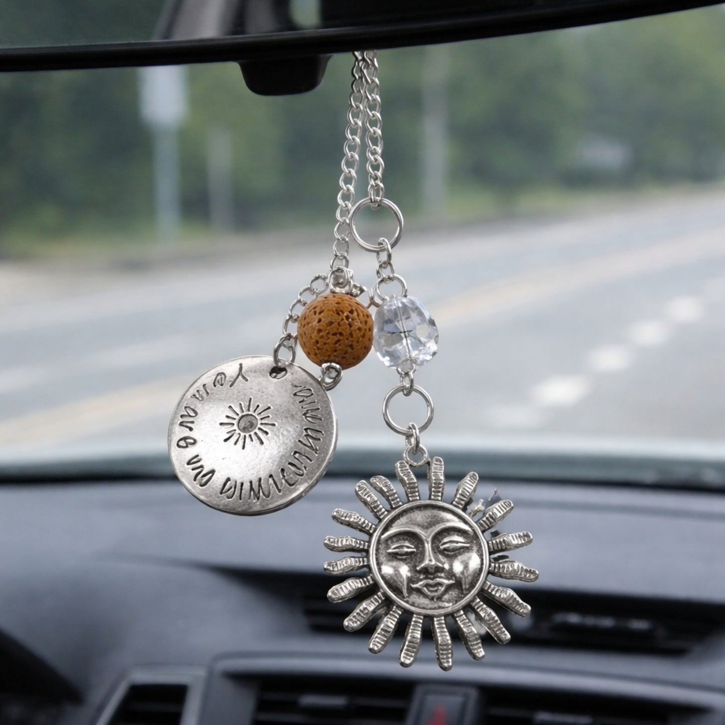 Sun rearview mirror charm shown hanging from a car mirror — handmade boho car accessory