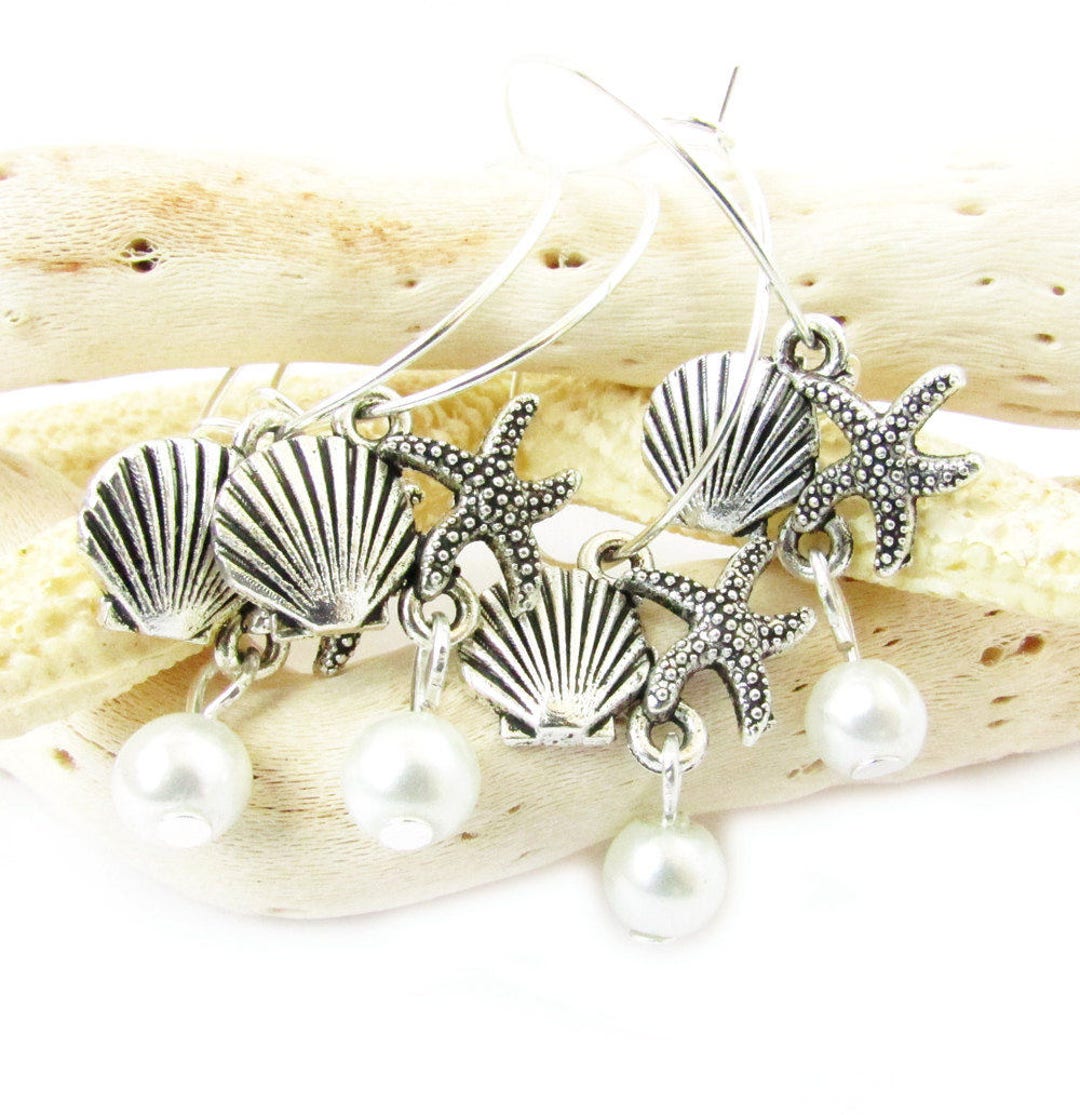 Silver hoop earrings with multiple seashell, starfish and pearl charms