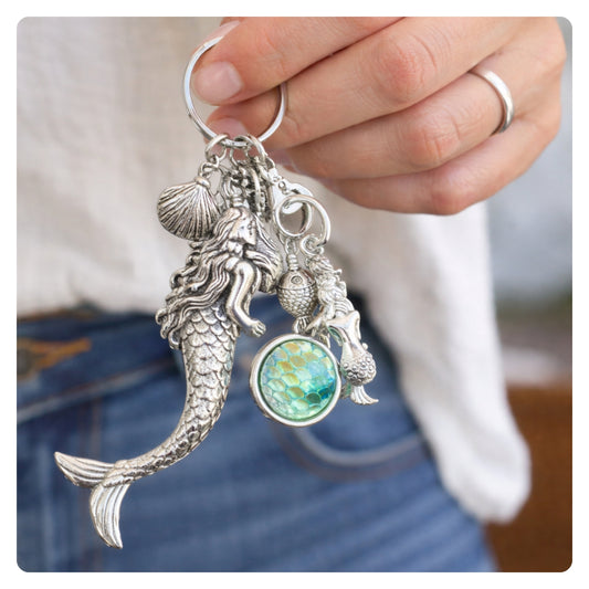 Mermaid beach car mirror charm and tropical purse keychain shown on a flat lay — handmade coastal accessory