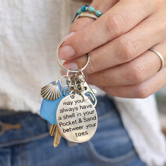 Sea glass starfish shell charm keychain shown on a flat lay — handmade beach lover gift