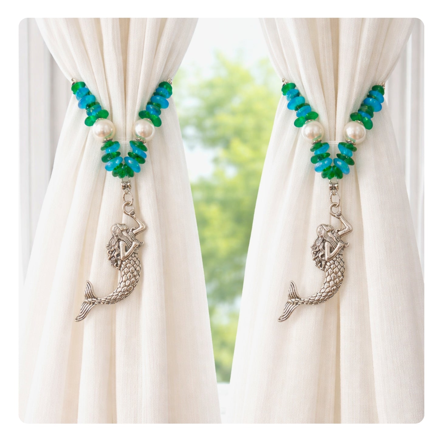 Set of two mermaid sea glass and pearl curtain tiebacks shown styled on sheer curtains — handmade coastal beach home decor