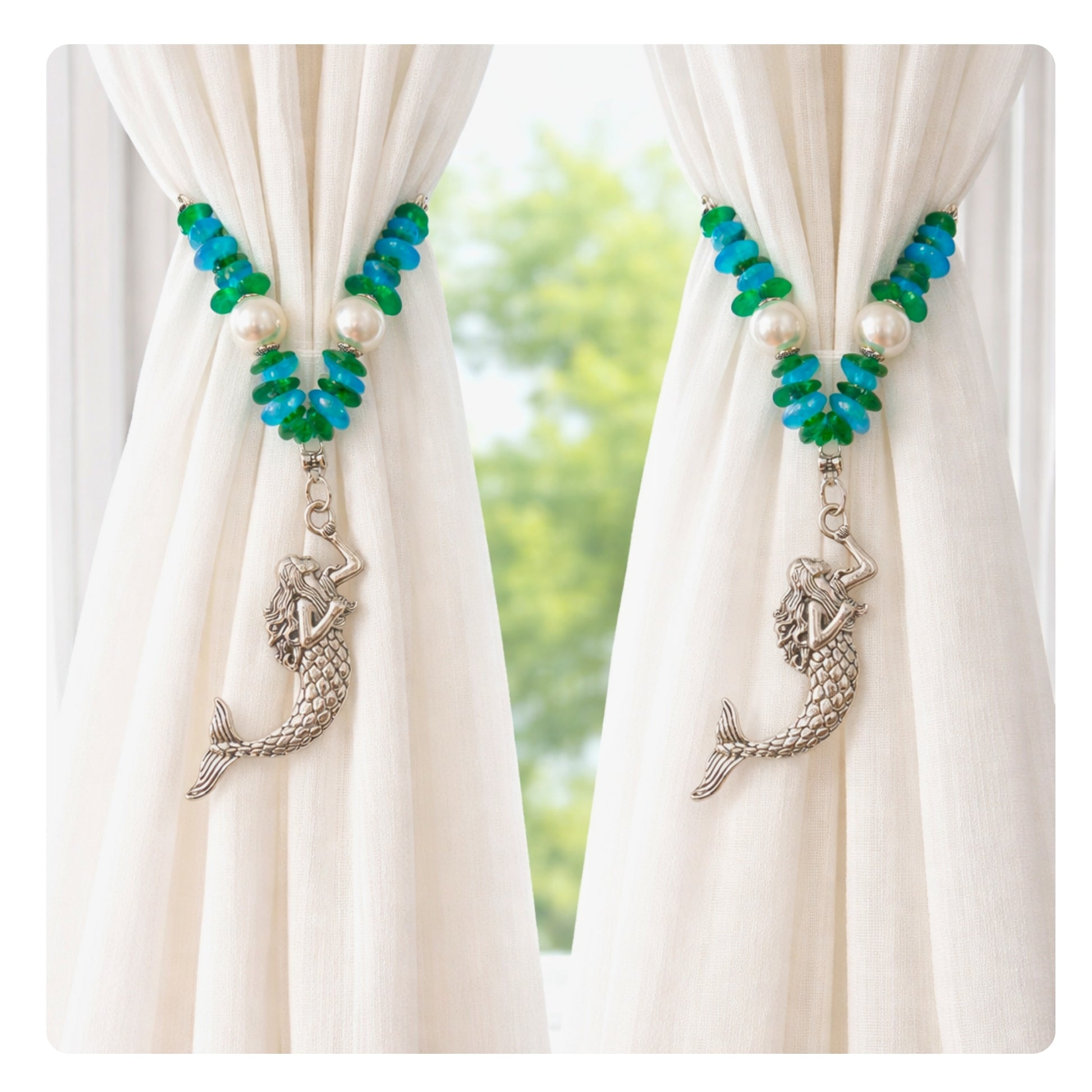 Set of two mermaid sea glass and pearl curtain tiebacks shown styled on sheer curtains — handmade coastal beach home decor