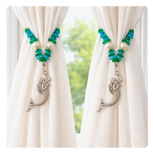Set of two mermaid sea glass and pearl curtain tiebacks shown styled on sheer curtains — handmade coastal beach home decor