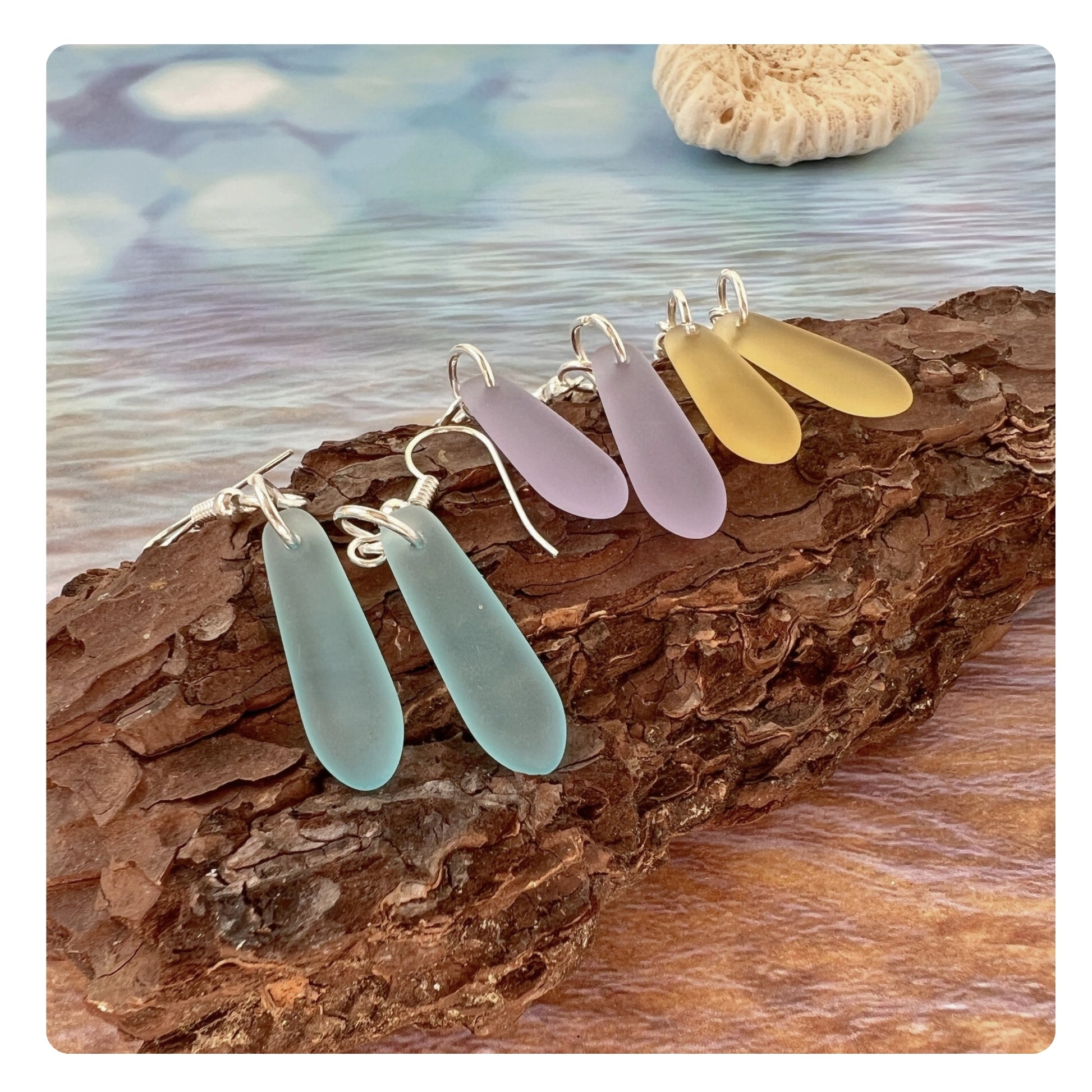 Sea glass teardrop dangle earrings shown on a model — handmade beach jewelry
