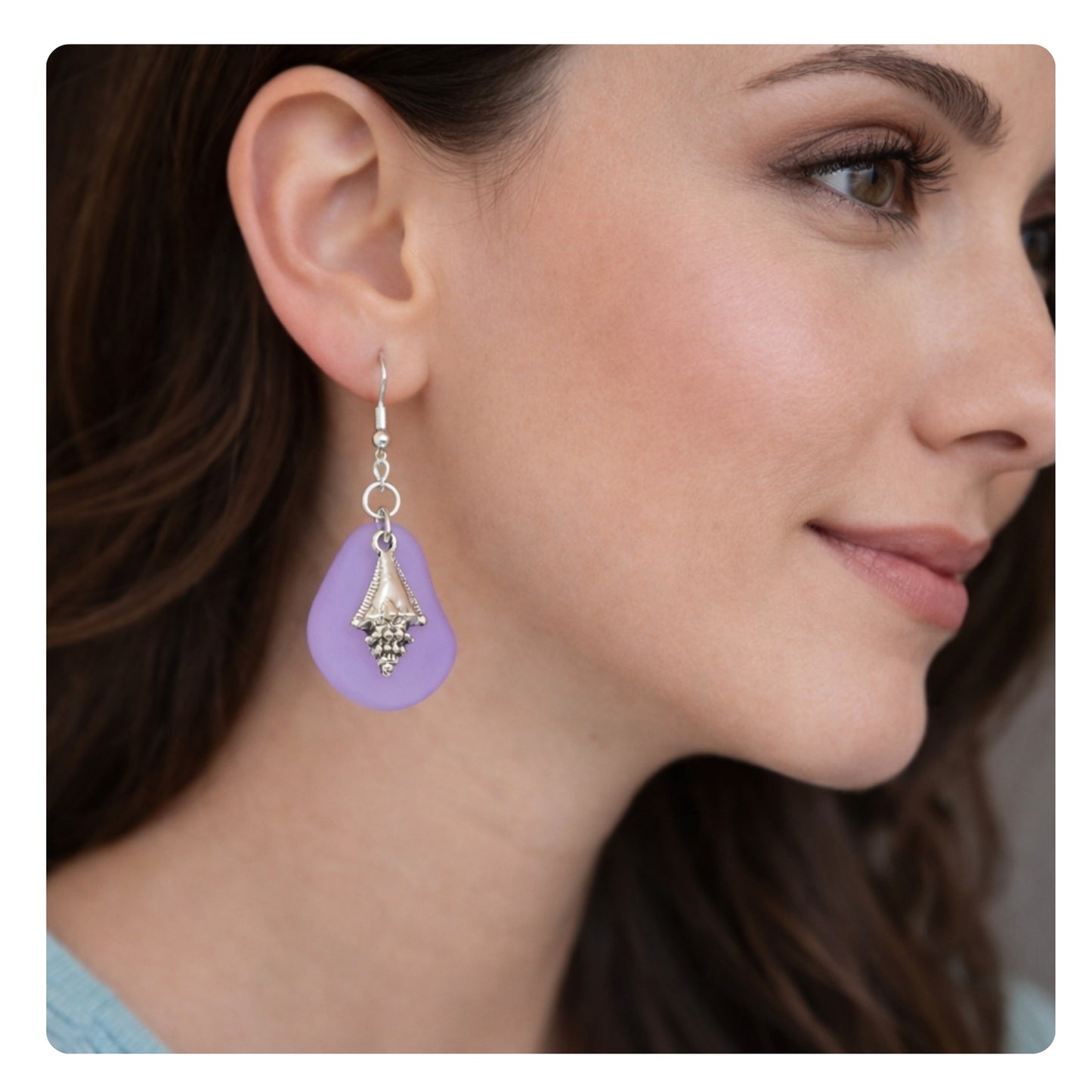 Purple and blue seashell dangle earrings shown on a model — handmade sea glass beach jewelry