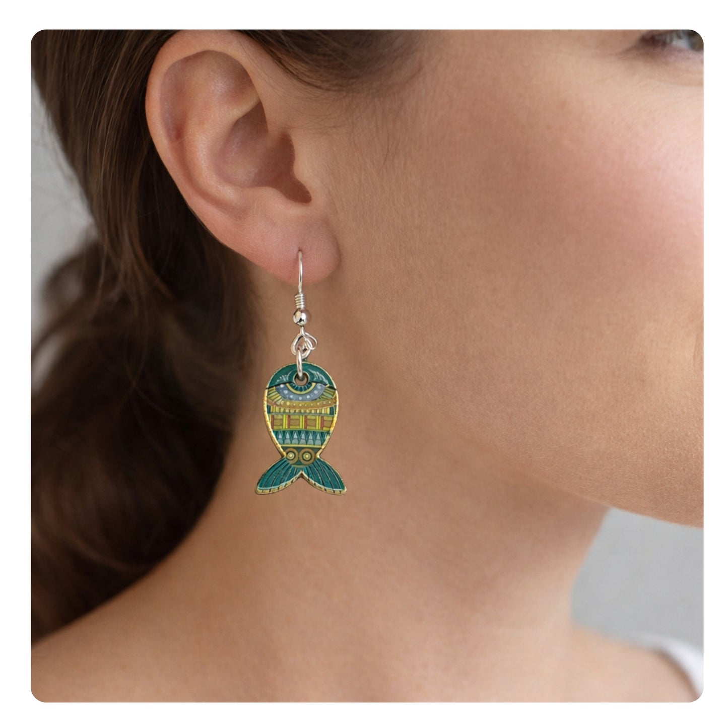 Whimsical enamel fish dangle earrings shown on a model — colorful beach jewelry