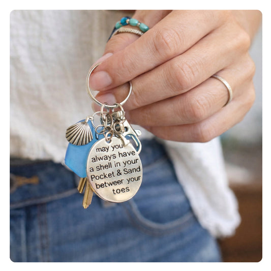 Sea glass and quote beach charm keychain shown on a flat lay — handmade coastal gift