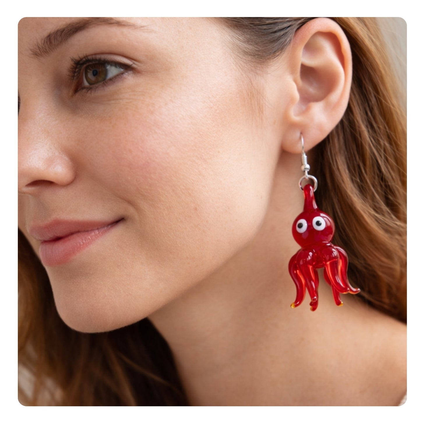 Red glass octopus dangle earrings shown on a model — handmade nautical beach jewelry