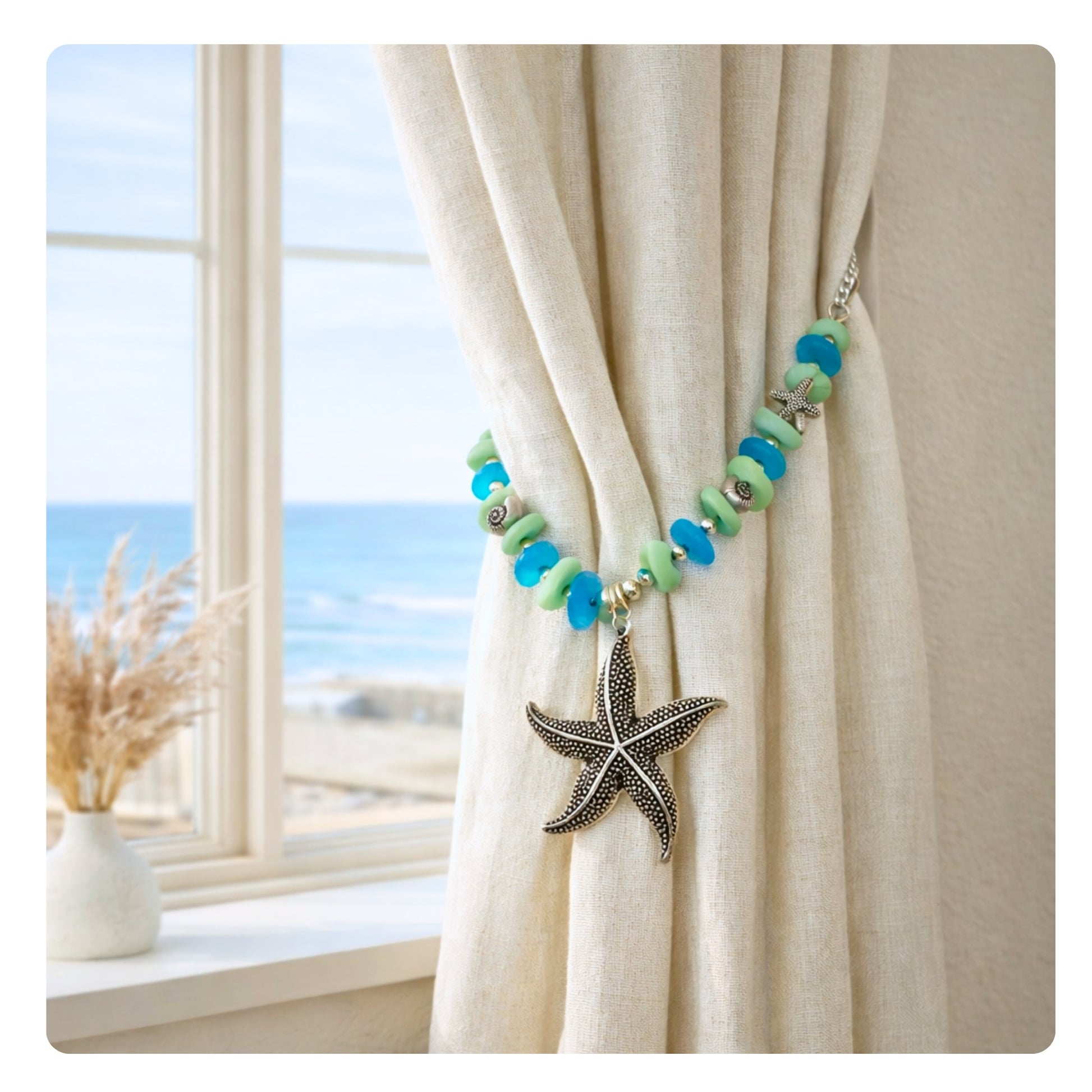 Set of two sea glass and starfish curtain tiebacks shown styled on sheer curtains — handmade coastal beach home decor